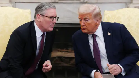 PA Media UK Prime Minister Sir Keir Starmer leans forward as he talks to US President Donald Trump during a meeting at the White House in February 2025.