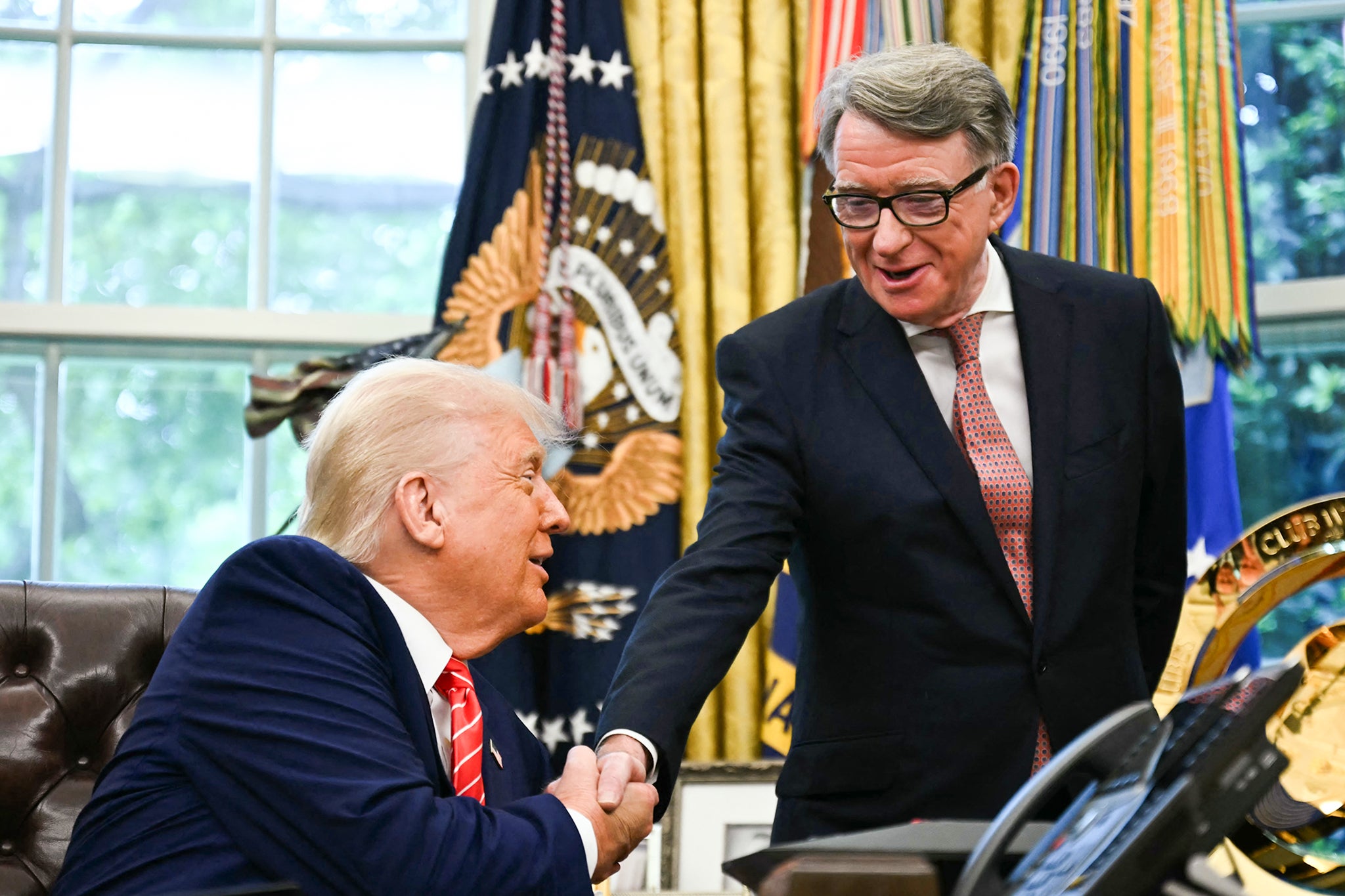 US President Donald Trump shakes hands with British ambassador to the United States Peter Mandelson after making a trade announcement in the Oval Office of the White House in Washington, DC